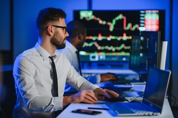 Financial Analyst Talking to Investment Banker in the Evening at Work.