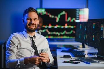Holding Dollar bills in the stock market. Investor counting money after making it big on the stock market
