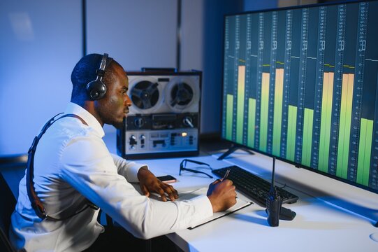 Secret agent listens on the reel tape recorder. Officer wiretapping in headphones