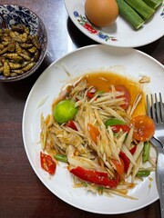 Spicy papaya with black crab Thailand called farmer crab and fresh shrimp that is famous of Thailand Street food.
