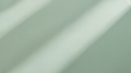Soft green background with diagonal light and shadow streaks image