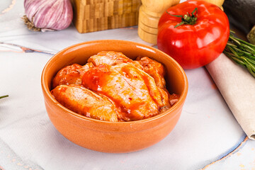 Raw marinated uncooked chicken wings