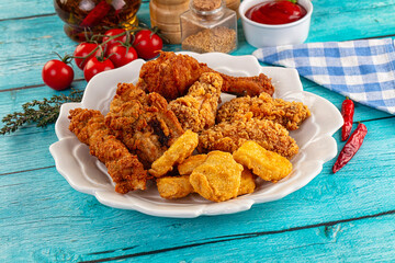 Golden crispy fried chicken mix - wings, drumsticks, nuggets and strips