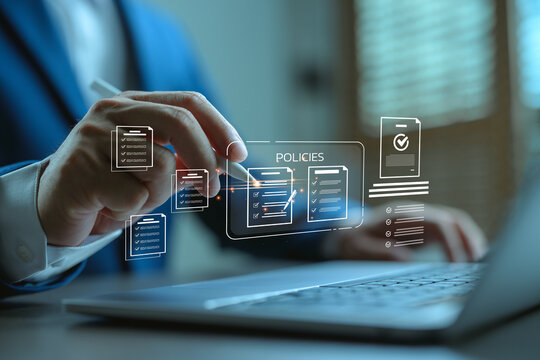 Businessman reviewing digital policy documents on laptop, symbolizing data governance, corporate compliance, document management system, and cybersecurity regulation.
