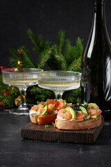 Avocado and salmon appetizer on the Christmas table. Canapes with fish and caviar.