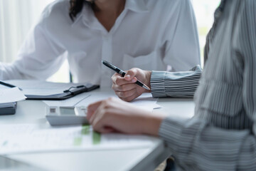 Two Asian business people working together in an office