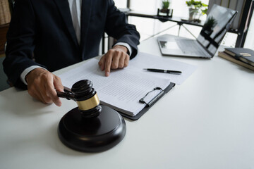Lawyers meeting with legal counsel, holding lawyer's hammers
