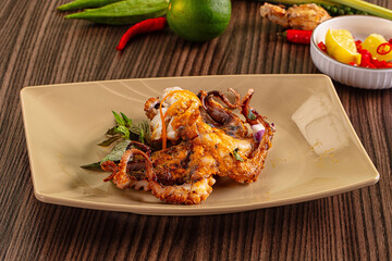 Gourmet grilled whole octopus served lime