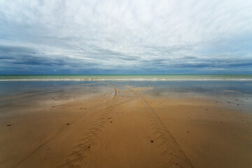 Tractor tracks on the beach of Bricqueville-sur-Mer village in Normandy region