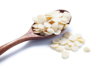 sliced ​​almonds in a wooden spoon isolated on white background
