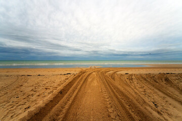 Tractor tracks on the beach of Bricqueville-sur-Mer village in Normandy region