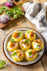 Potato tartlets filled with cottage cheese and marinated mushrooms.