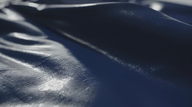 Abstract Black Leather Surface Texture Moving Smoothly in Light