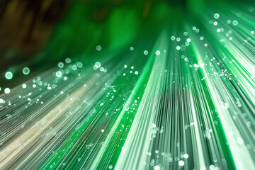 Abstract green fiber optic light trails against dark background creating dynamic technology concept. Glowing strands of light with bokeh effect symbolizing digital communication and connectivity.
