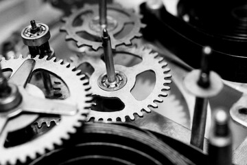 The mechanism of an old mechanical alarm clock. Gears and parts.