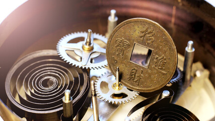 Chinese coin and mechanical watch mechanism. Macro.