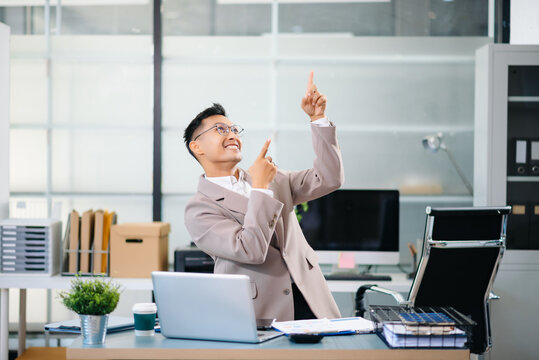 Cheerful businessman checking time feeling motivated waiting for leaving office do on their tablet, laptop and taking notes at office - Powered by Adobe