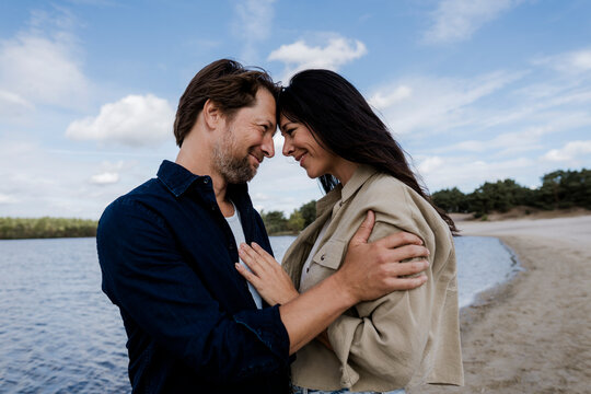 Couple embracing on a windy beach showing love trust and connection