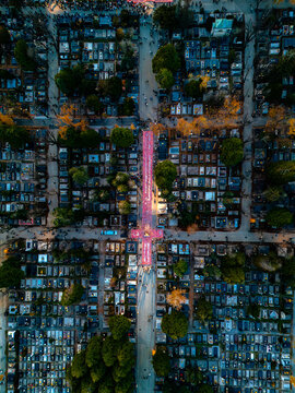 Aerial view of endless rows of gravesites stretch out in geometric precision, illuminated by soft light, casting long shadows across Mirogoj, Zagreb, Zagreb, Croatia.