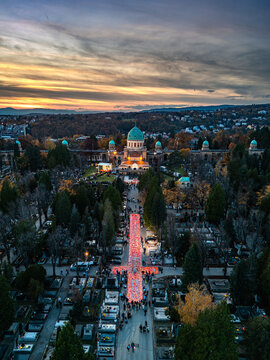 Aerial view of Mirogoj Cemetery's grand arcades and the Church of Christ the King under a painted twilight sky, Zagreb, Zagreb, Croatia.