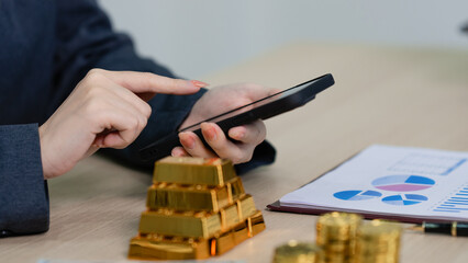 businesswoman evaluates gold investments for wealth protection and profit