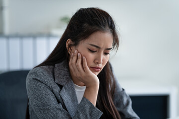 woman handles stressful at office, appearing tired and sad at work