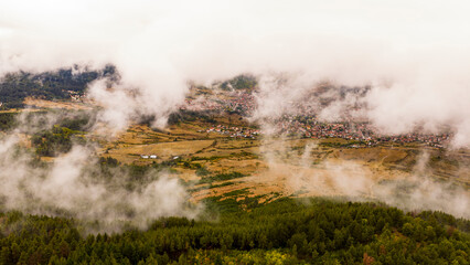 Aerial view of Rakitovo town covered by morning fog in the Rhodope Mountains, Bulgaria