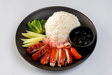 Barbecue roasted duck on rice in the black plate on a white background