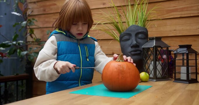 Kid Cutting Pumpkin Eyes Before Halloween Night | 4k, 12 Bit Braw Source Video