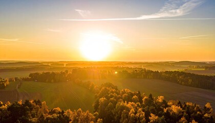 Golden Hour Sunset Over Agricultural Fields and Forests With Wispy Clouds in a Vast Landscape