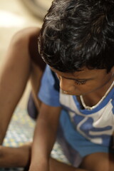 Close-up view of a young child eating homemade food, with small bits of food around the mouth,  innocence of childhood mealtime and the emotional bond of being lovingly fed by a caring hand.