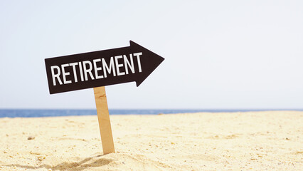 Retirement planning written on the sign on the beach with the ocean in the background. Relax you are retired