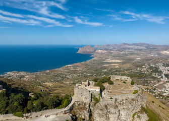 Fototapeta premium Aerial view of The Balio Towers, a group of medieval fortifications located in Erice, Sicily, Italy. At the summit of Mount Erice, the towers once served as a key defensive outpost overlooking the sea