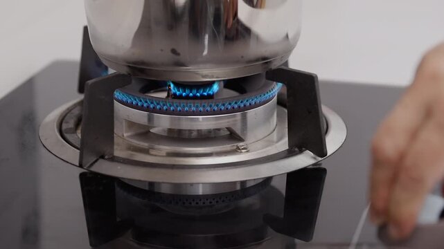 Light the stove for start cooking on drop In gas counter in kitchen.