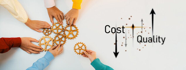 Obraz premium A diverse group of hands engages in assembling gears, symbolizing teamwork and the balance of cost and quality in effective business strategies. Trope