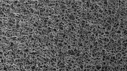 Background of wire doormat. close up of rough mat surface. Seamless abstract doodle texture. doormat made of synthetic material.