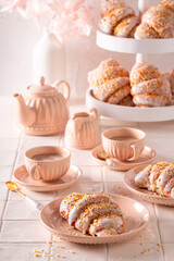 Golden saint martin's croissant with poppy seeds and icing.