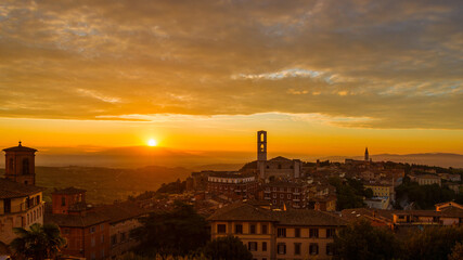 Beautiful dawn sky with morning haze over the old city of Perugia, with medieval bell towers and Umbria countryside in the background
