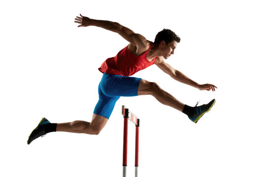 A male athlete in red and blue hurdles over an obstacle, demonstrating agility and speed in a track and field event. background removed