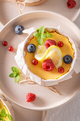 Sweet lemon curd as small monoportion in wooden form.