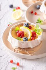 Delicious New York cheesecake as small monoportion in wooden form.