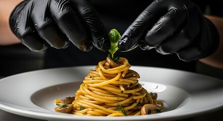 Chef preparing gourmet pasta dish with mushrooms and basil garnish