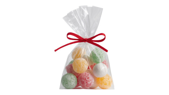 A clear cellophane bag holds an assortment of colorful, sugar-coated round candies, tied with a festive red ribbon. background removed
