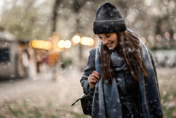 Woman enjoying the snow in the city park