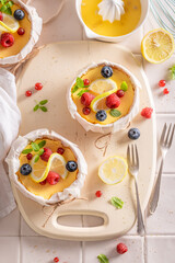 Tasty lemon curd as small monoportion in wooden form.