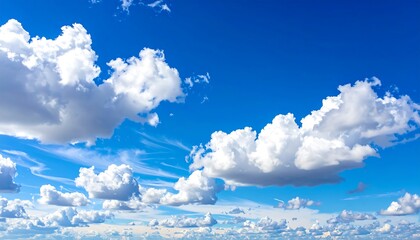Fluffy white clouds drift across a vibrant blue sky, creating a peaceful and expansive daytime vista