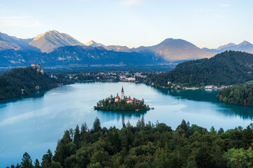 Evening View of Lake Bled with Island Church and Sunlit Mountains in Blue Hour