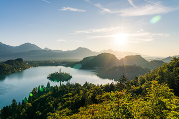 Lake Bled with Island Church in Backlight and Sunstar at Sunrise