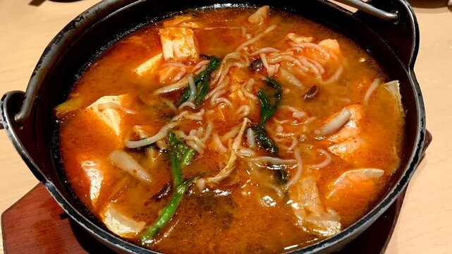 Salmon belly with spicy miso soup served in a bowl