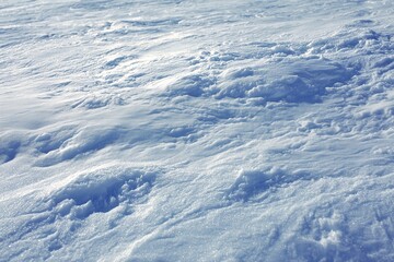 Textured Snow Surface Under Bright Light